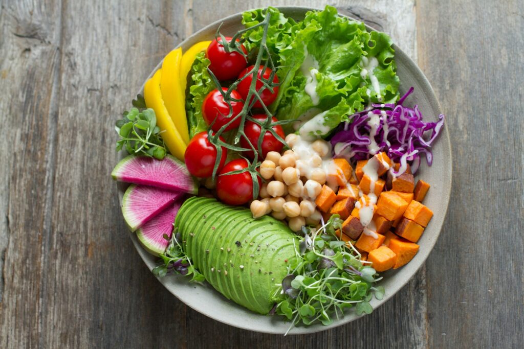 A vibrant bowl of fresh vegetables, greens and plant-based ingredients